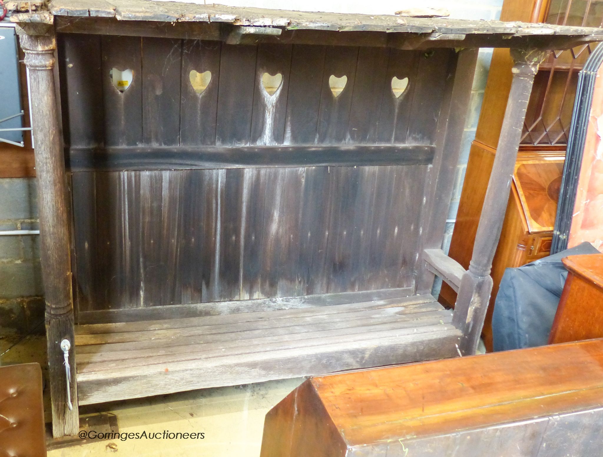 An Arts & Crafts Voysey style oak garden arbour bench seat, (in need of some restoration), length 205cm, depth 90cm, height 180cm